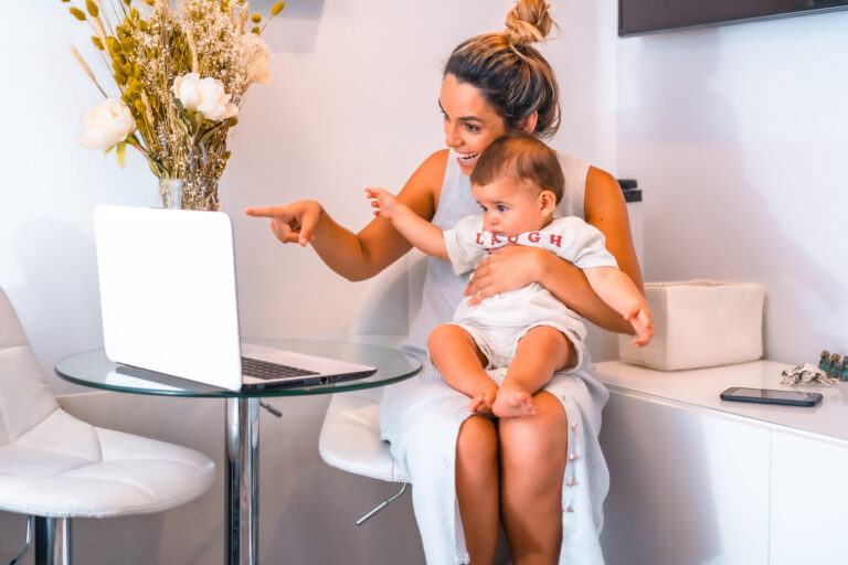 young-mother-with-her-son-sitting-front-table-with-computer